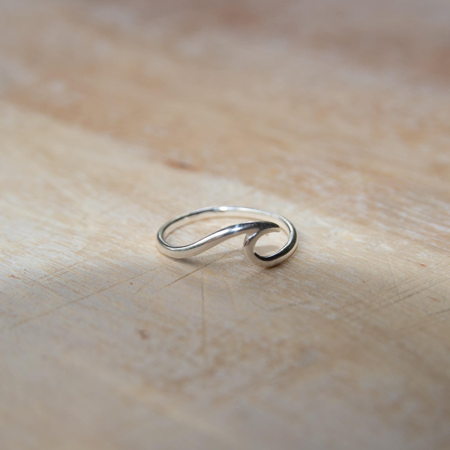 Sterling Silver Wave Ring on a wooden table
