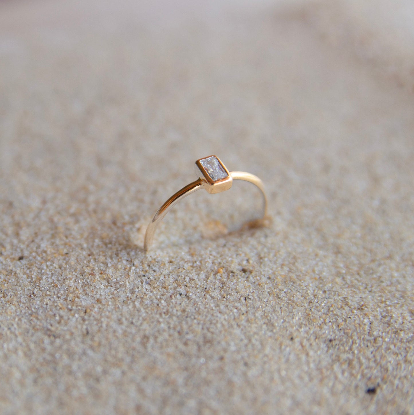 Gold Plated Stone Ring on the sand