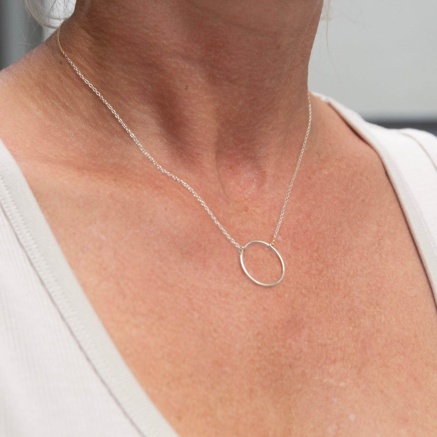 Sterling Silver Circle Pendant Necklace worn by a woman