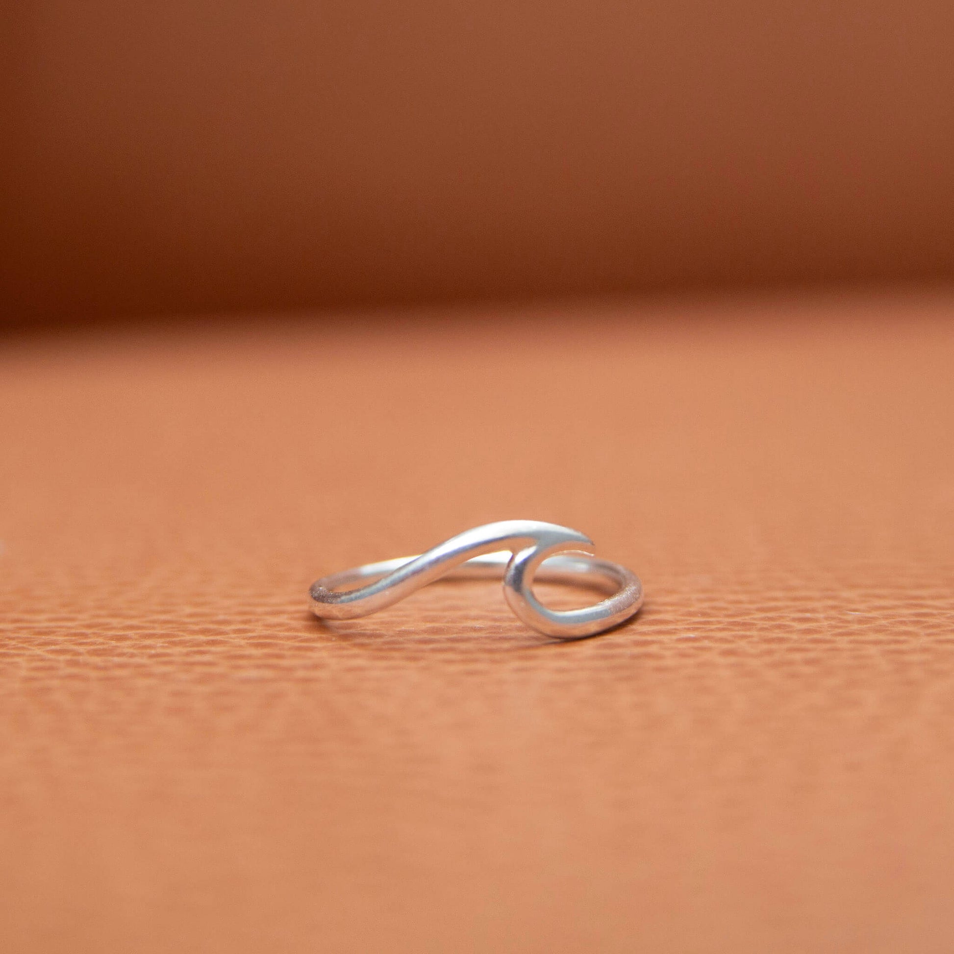 Sterling Silver Wave Ring on a leather background