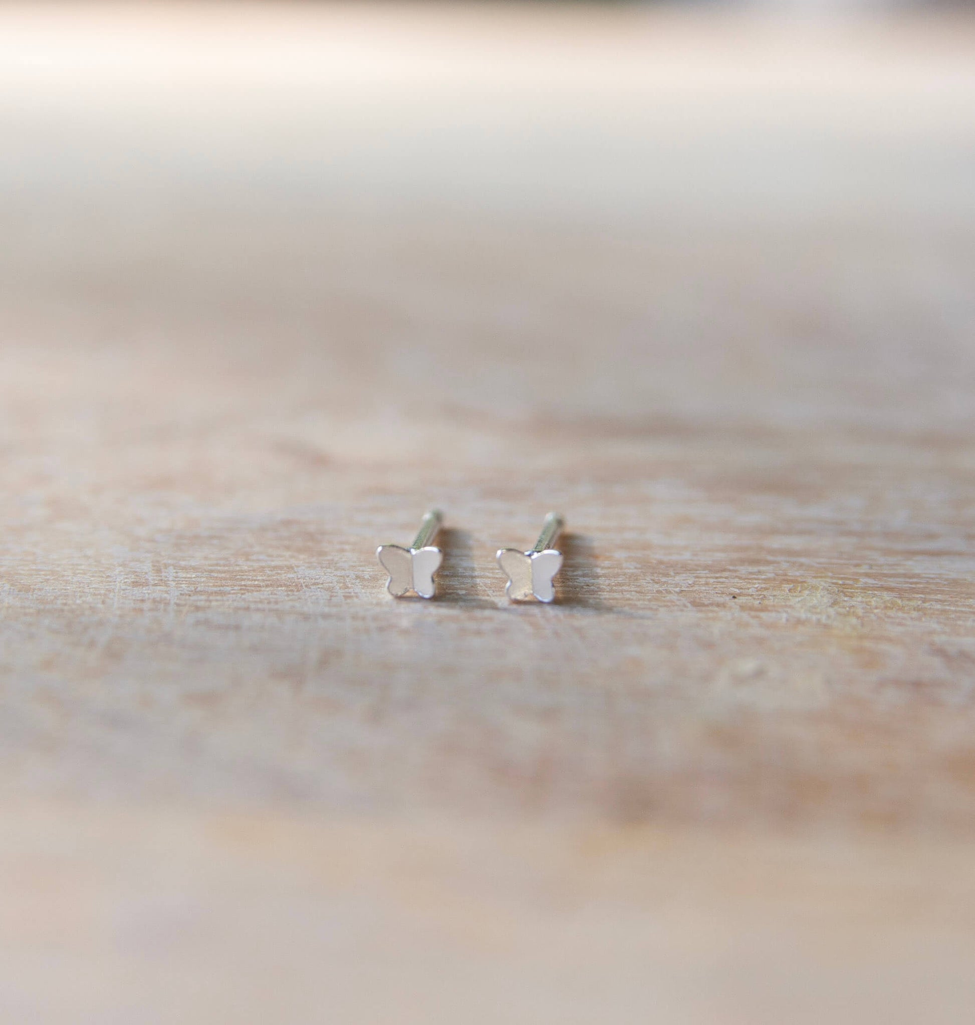 silver butterfly stud earrings close-up