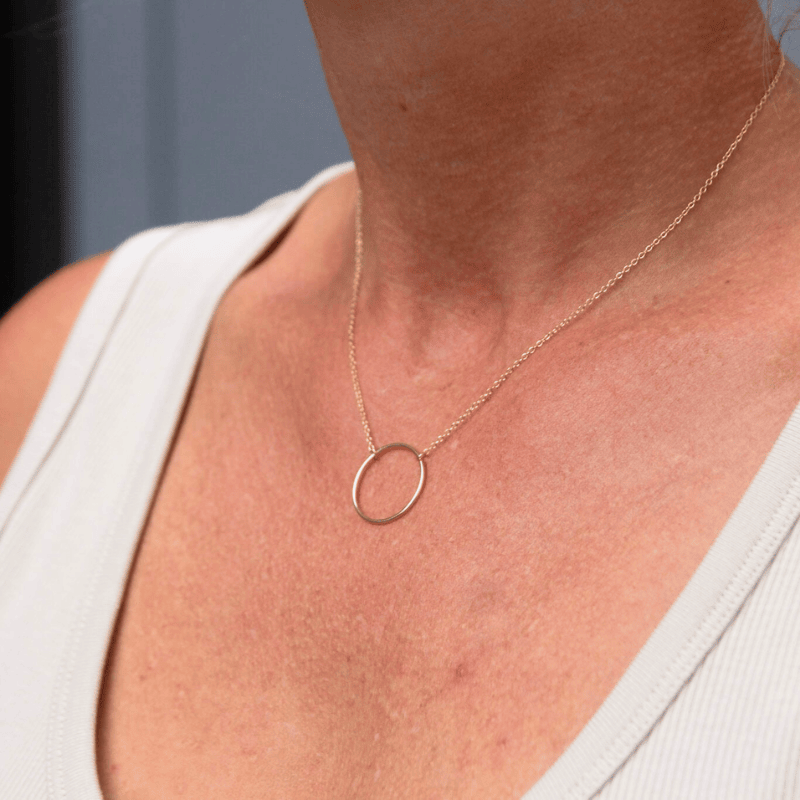 Gold Plated Circle Pendant Necklace worn by a woman