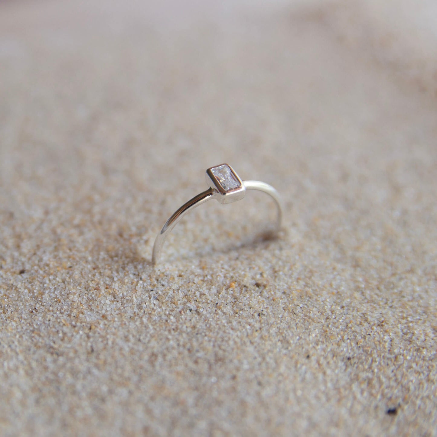 Sterling silver stone ring on sand