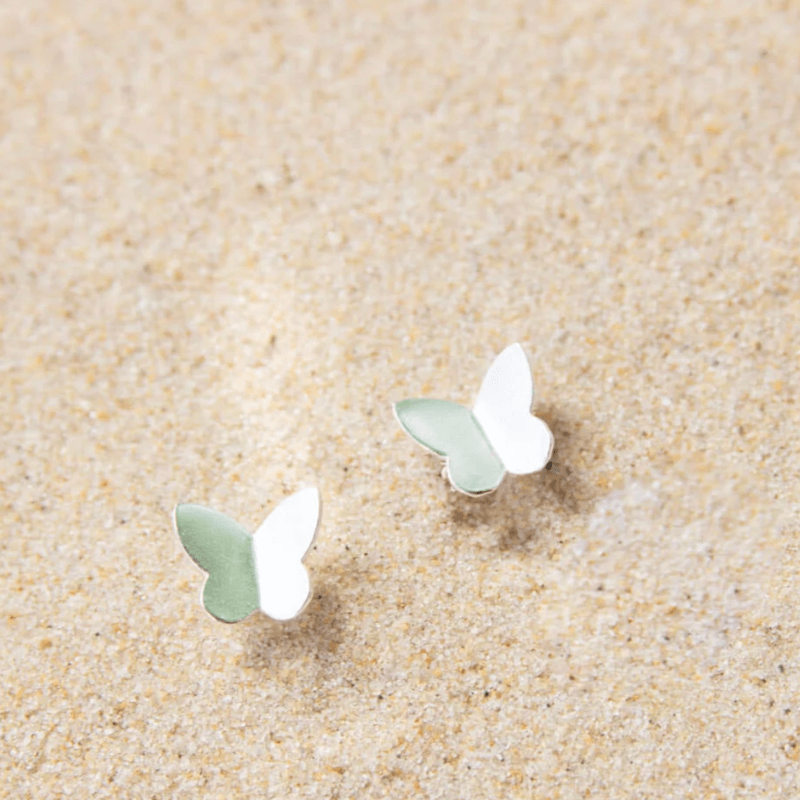 silver butterfly earrings in sand