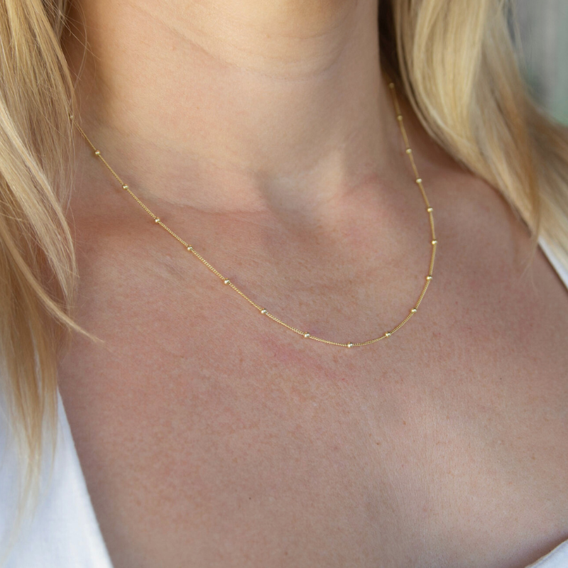 Gold necklace on a woman's neck