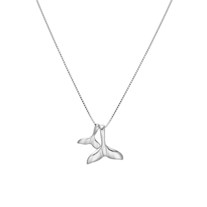 Silver whale tail pendant on a chain against a white background