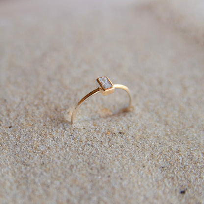 Gold Plated Stone Ring on the sand