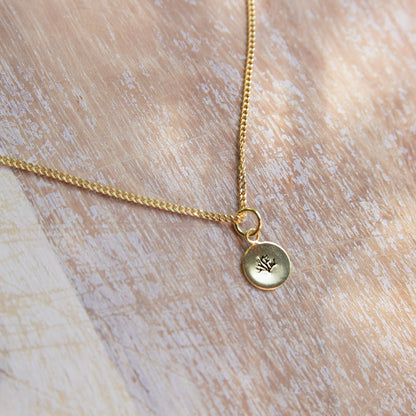 gold pendant with a coral