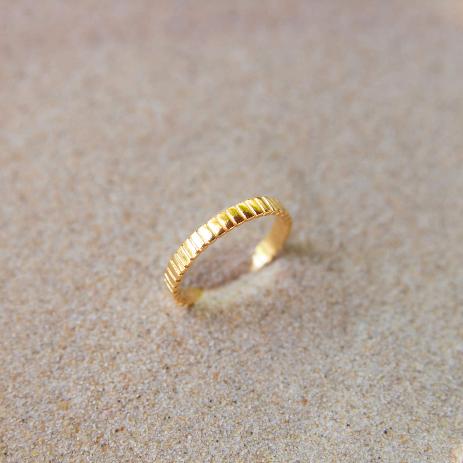 gold ring in sand