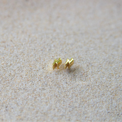 gold lightning bolt stud earrings in sand