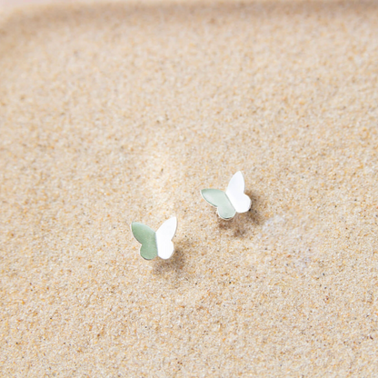 silver butterfly earrings in sand