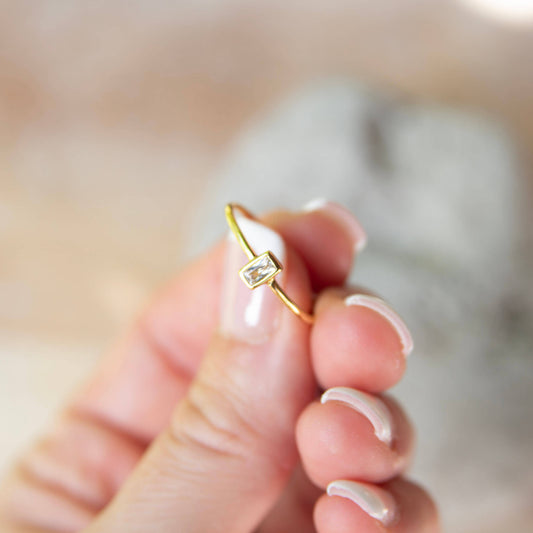 hand holding a gold ring