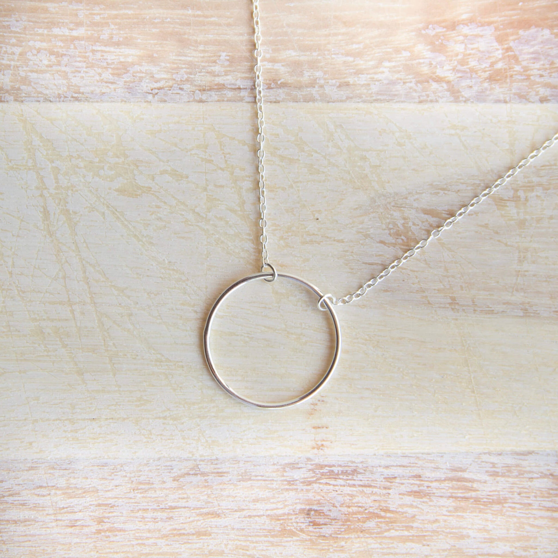 Sterling Silver Circle Pendant Necklace on a table