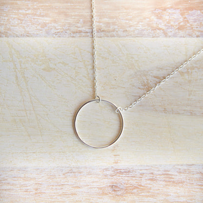 Sterling Silver Circle Pendant Necklace on a table