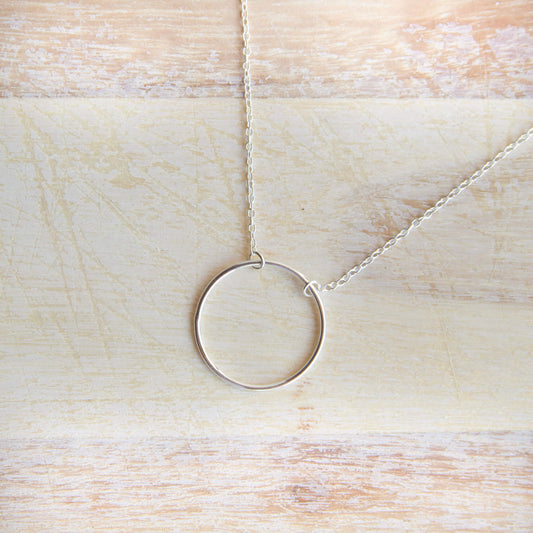 Sterling Silver Circle Pendant Necklace on a table