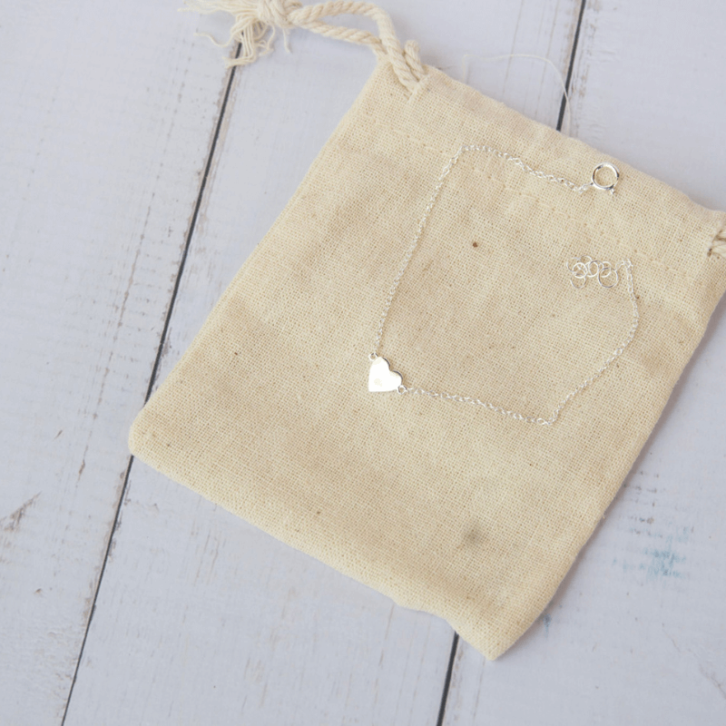 bracelet in silver with a love heart pendant on a natural background