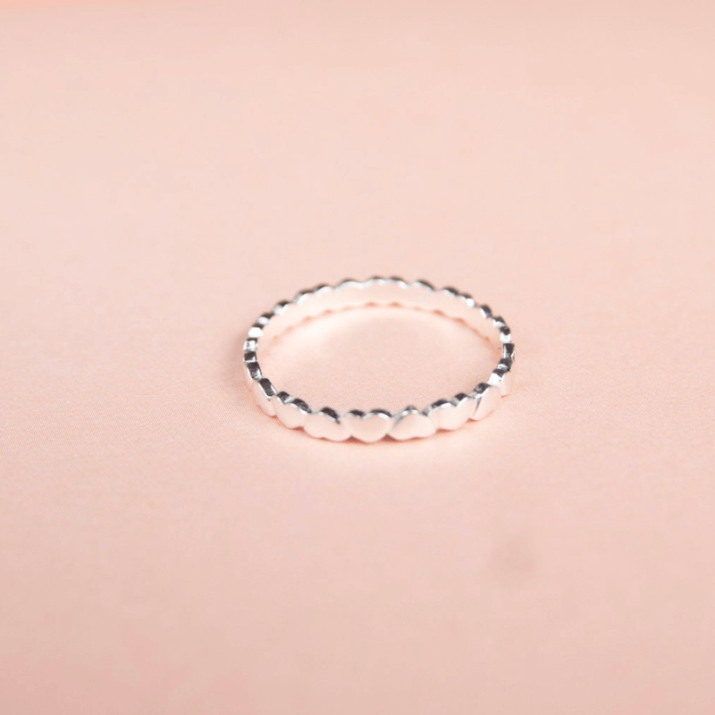 Silver ring on a pink background