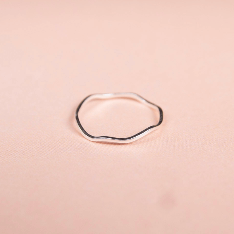 Silver ring on a pink background