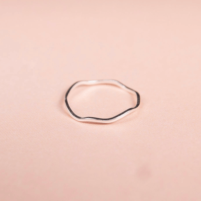 Silver ring on a pink background