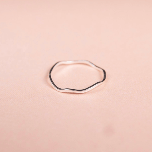 Silver ring on a pink background