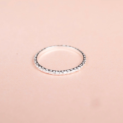Silver ring on a pink background