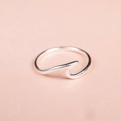 Silver ring on a pink background